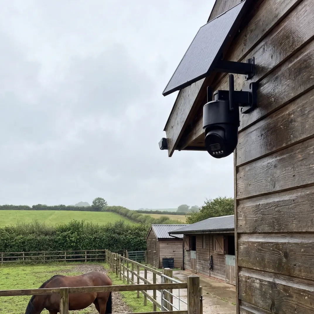 IP66-rated Solar 360 Mini security camera mounted in a muddy UK farmyard in wet weather